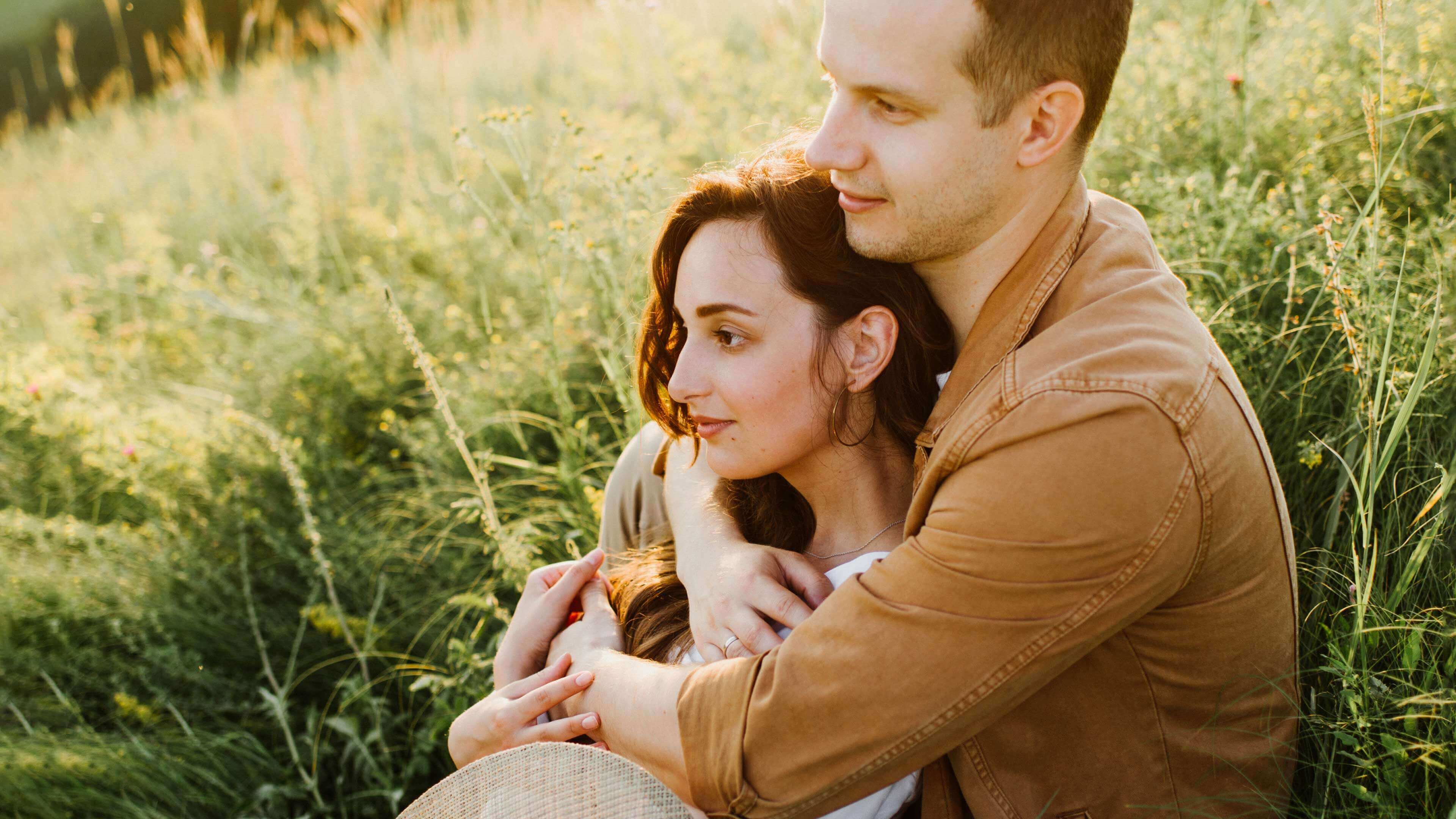Pärchen sitzt auf Feld