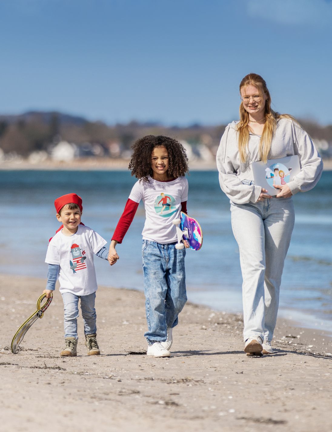 Foto von 2 Kindern und einer jungen Frau am Strand