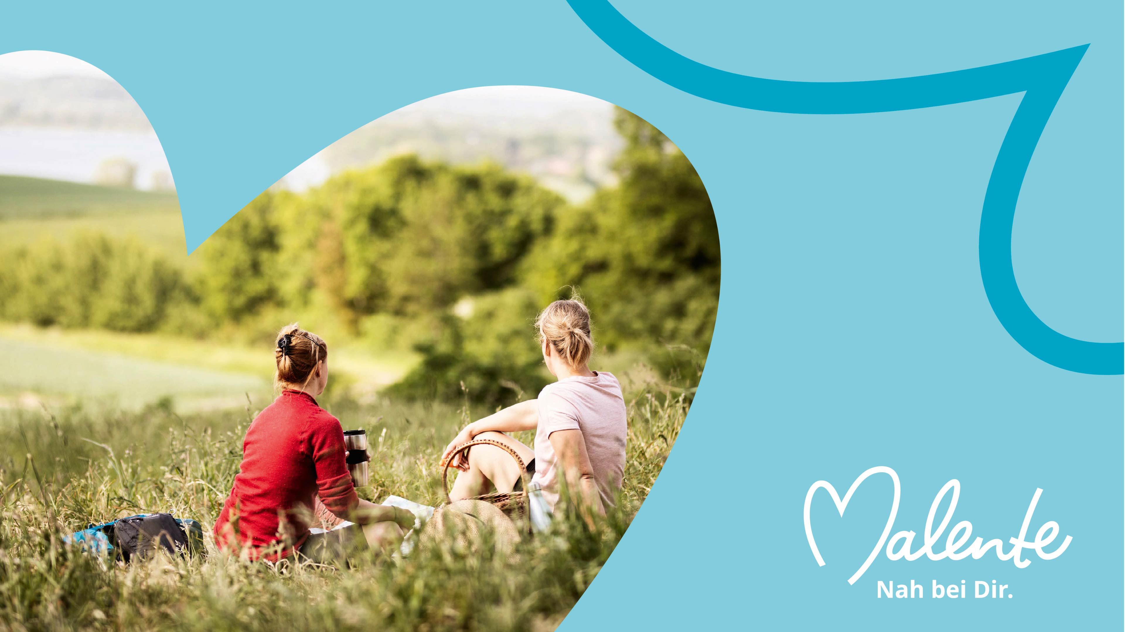 Foto von zwei Frauen beim Picknicken auf einer Wiese. Das Foto ist Herzförmig vor einem hellblauen Hintergrund. Daneben steht Malente nah bei dir.