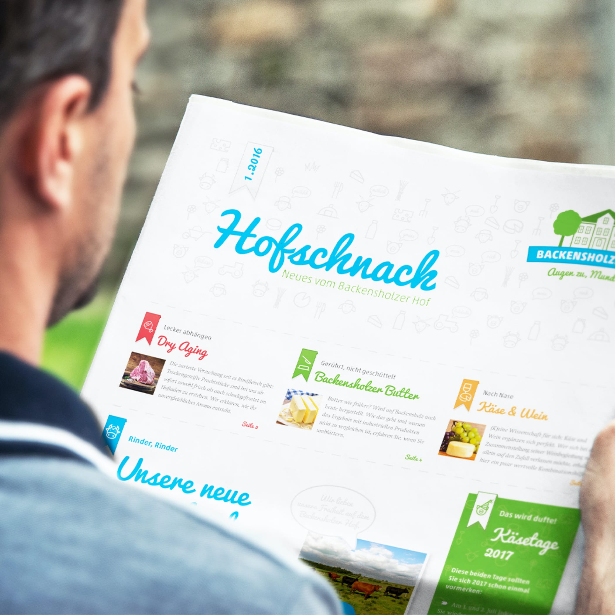 hochzwei_roba_teaser_03.jpg Blick über die Schulter eines Mannes, der das Magazin Hofschnack liest