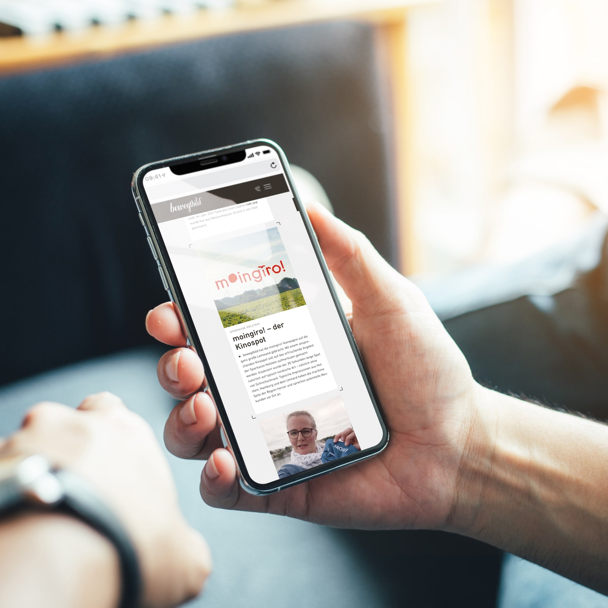hochzwei_bb_teaser_02.jpg Hand hält Smartphone, das moin giro auf der bewegtbild-Website zeigt