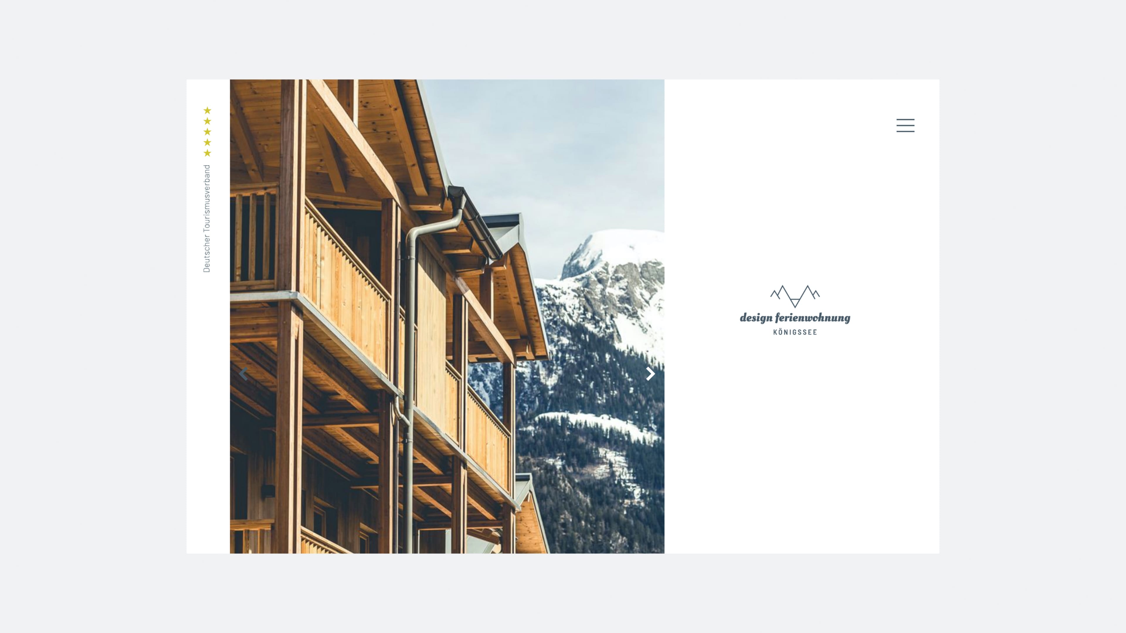 Neubau mit Holzbalkonen vor Berg im Hintergrund