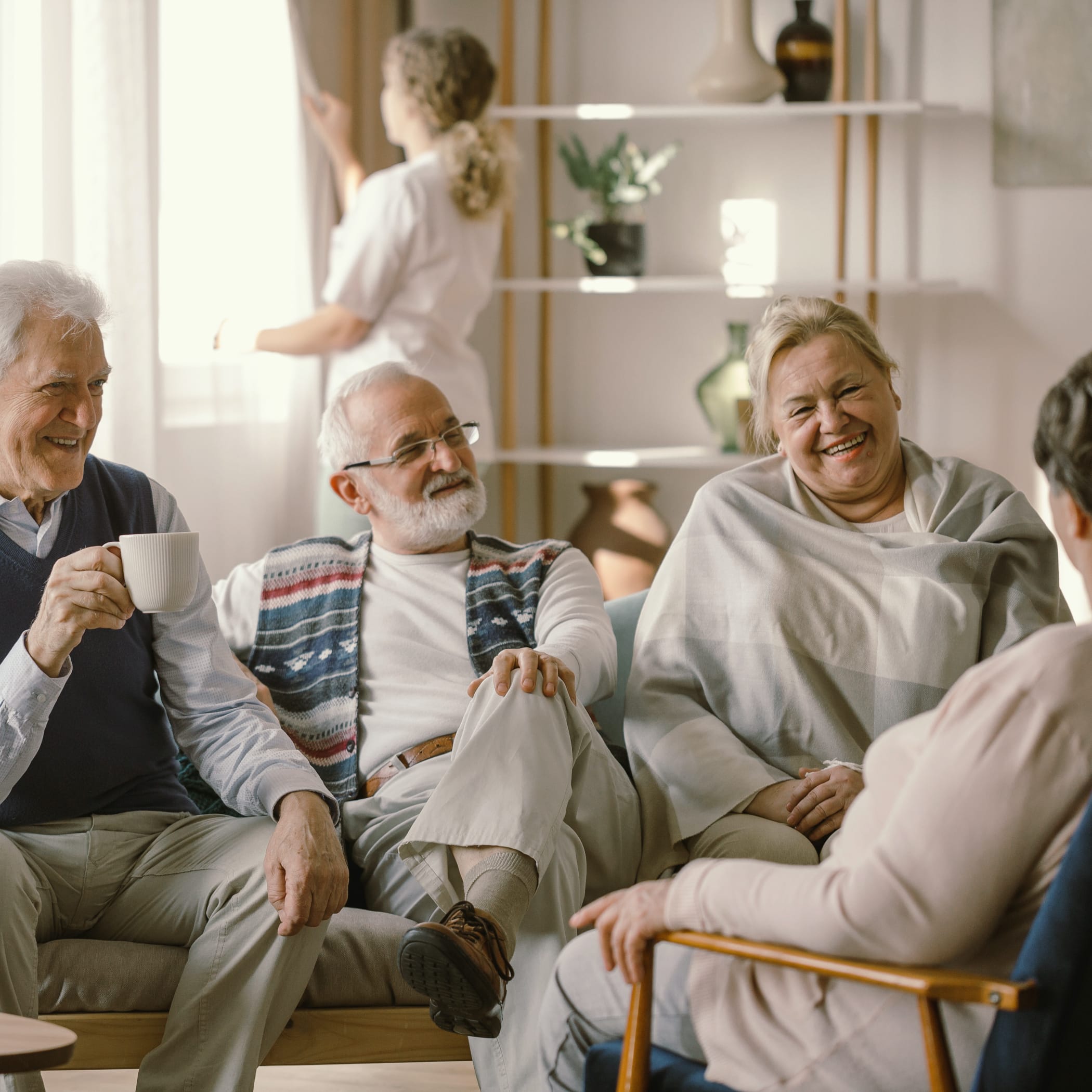 hochzwei_kaho_teaser_05.jpg Eine Gruppe an älteren Menschen sitzen in einem Sofa und unterhalten sich