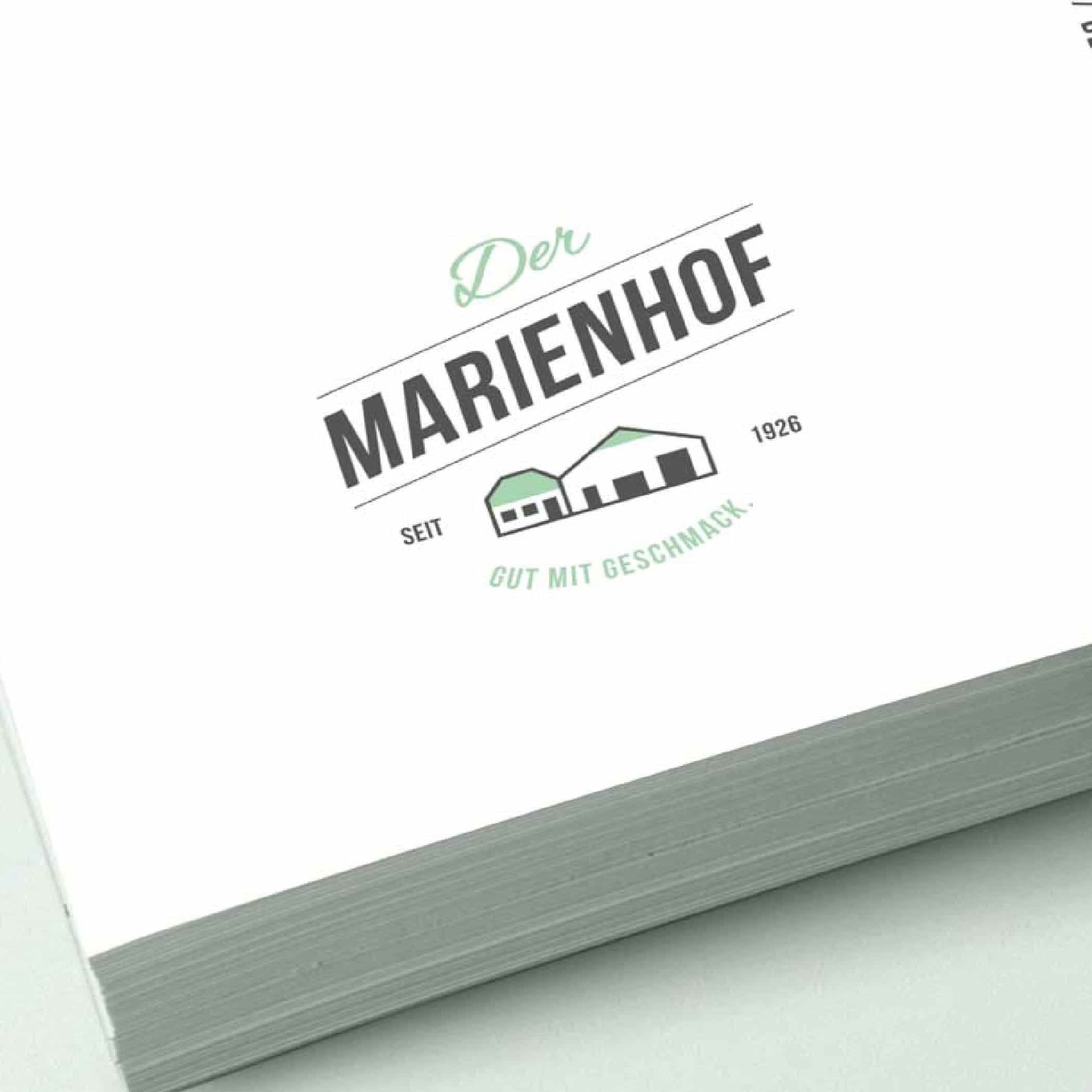 hochzwei_marienhof_teaser_04.jpg Der Marienhof Logo auf weißem Papier