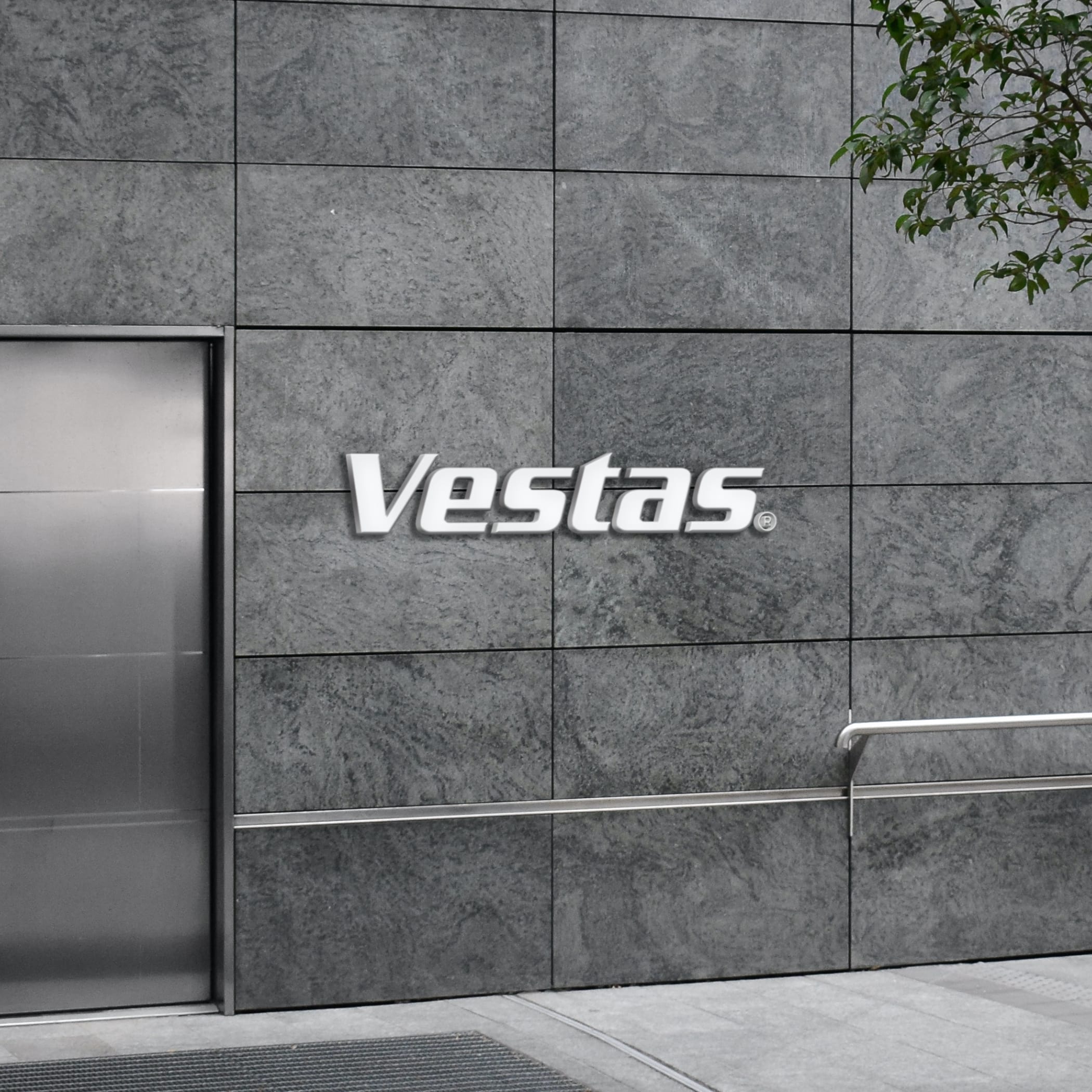 hochzwei_vestas_teaser_06.jpg Graue Steinwand mit Vestas Logo