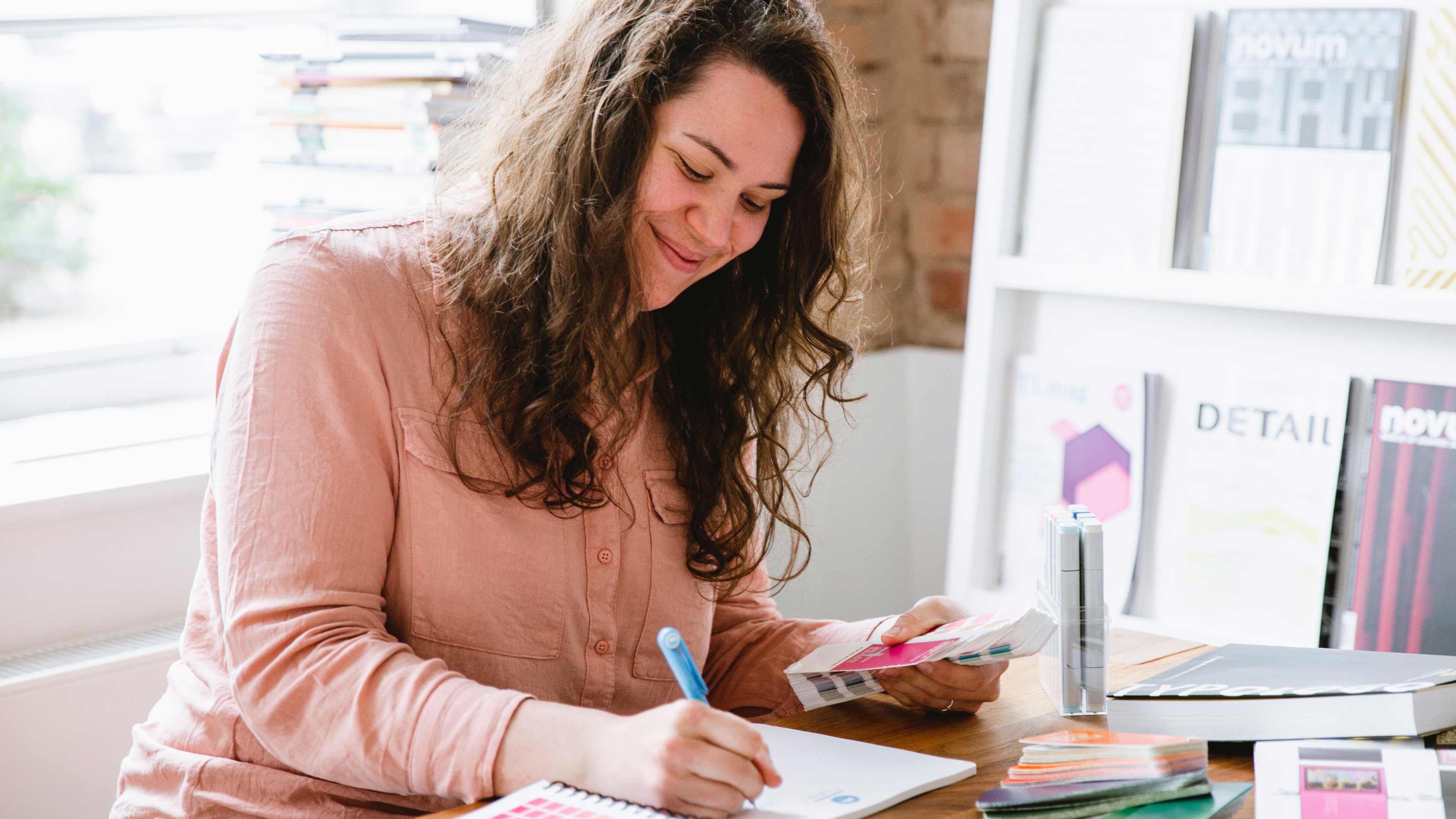 Hochzwei Mitarbeiterin schreibt in ihr Notizblock