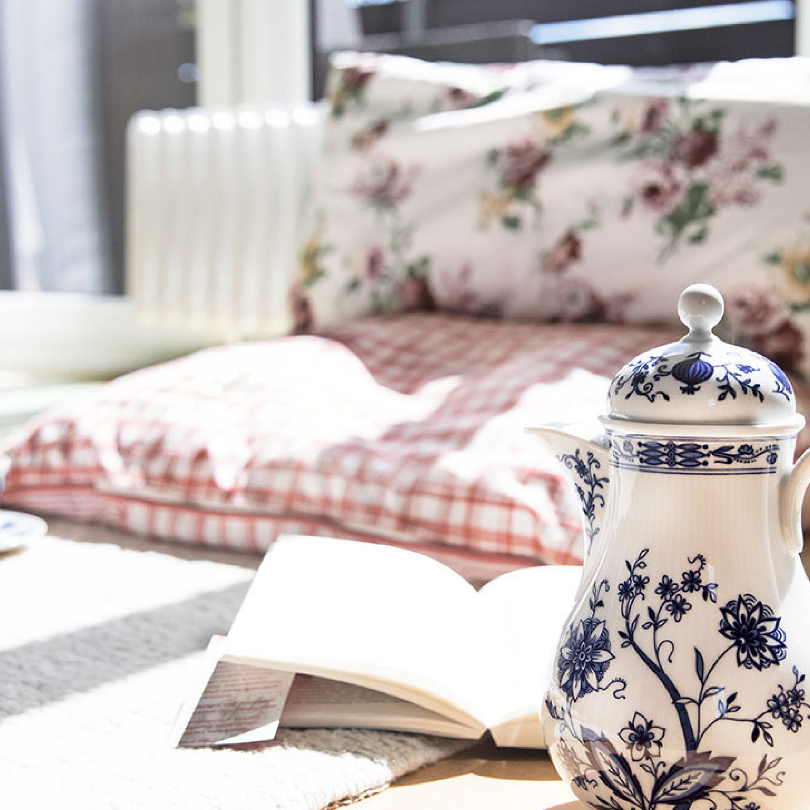 hochzwei_isa_teaser_06.jpg Eine weiße verzierte Teekanne steht auf einem Sofatisch