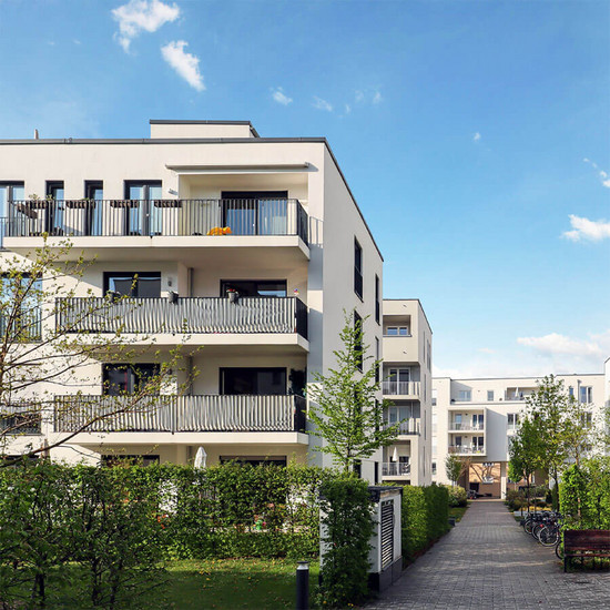 Von Haus aus Weiße Wohngebäude mit Grünfläche