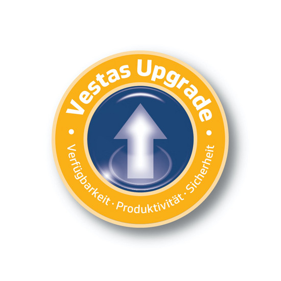 Gelb blauer Button von Vestas mit Pfeil in der Mitte